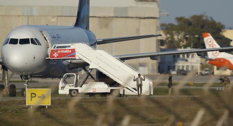 Two hijackers of a Libyan Afriqiyah Airways Airbus A320 surrender to Maltese military on the runway at Malta Airport