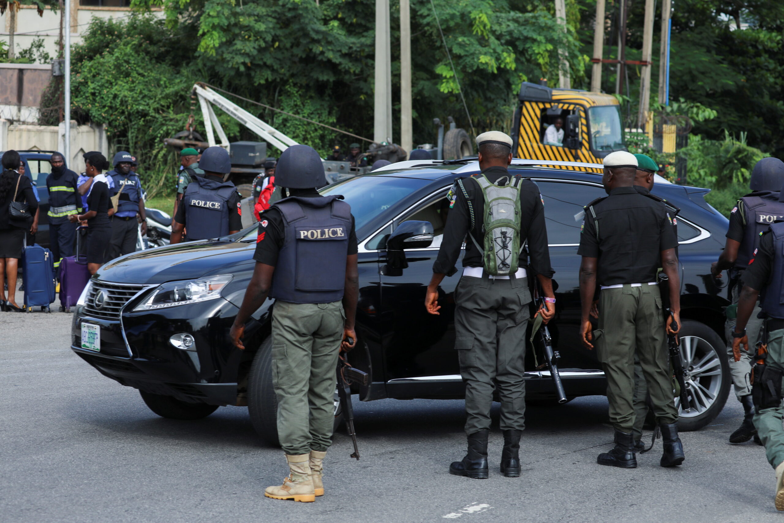 Police officers are seen conducting checks on vehicles at the Federal High court in Abuja